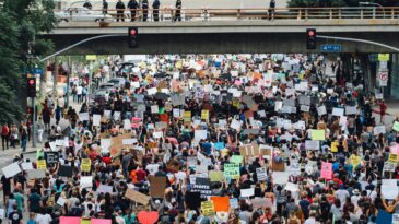 a large group of people holding up signs