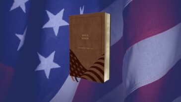 a picture of the God bless the usa bible with an american flag in the background