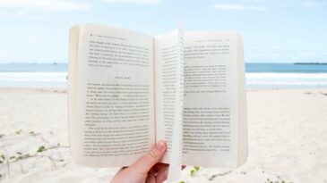 Someone reading a book on the beach